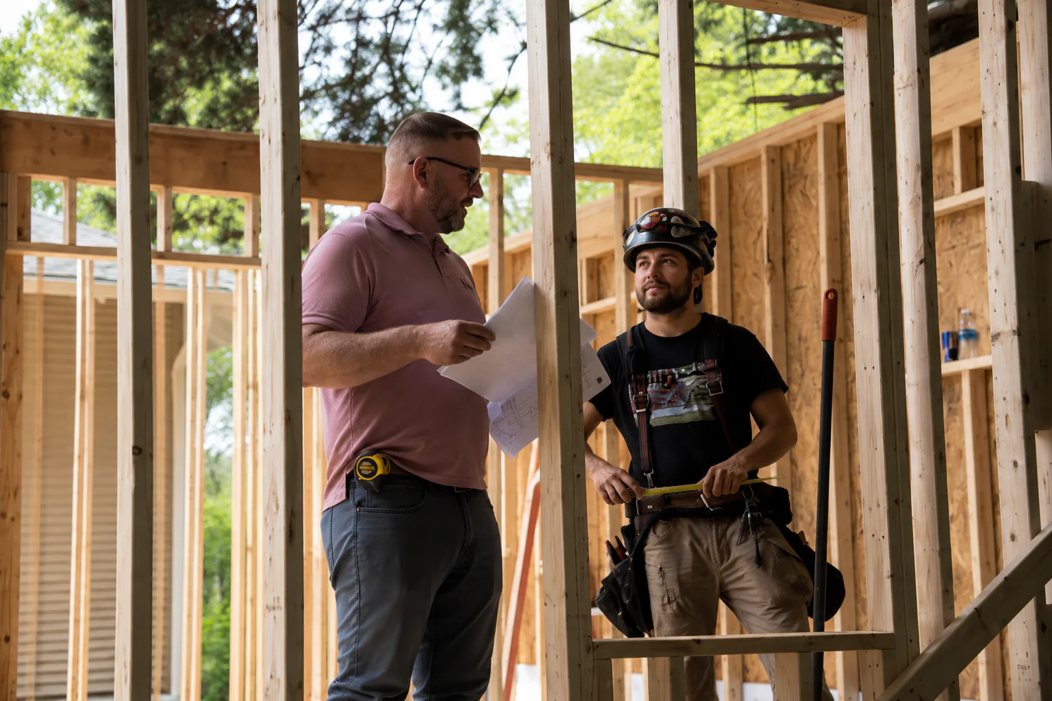 Versatile Edge owner Don Rice reviewing project plans with a framing partner during residential construction.