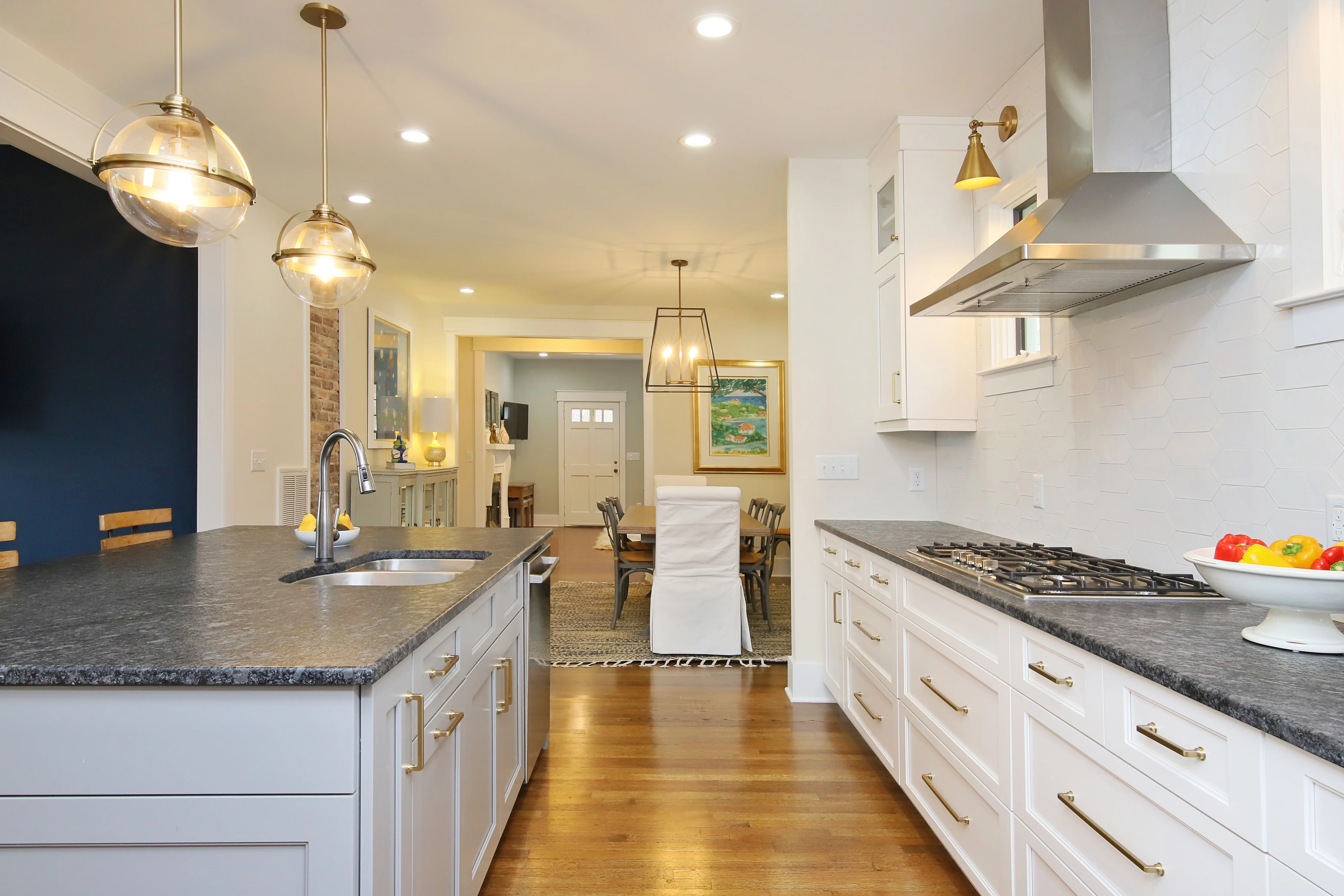 Completed Versatile Edge Hutter kitchen renovation with white cabinetry and an open dining connection