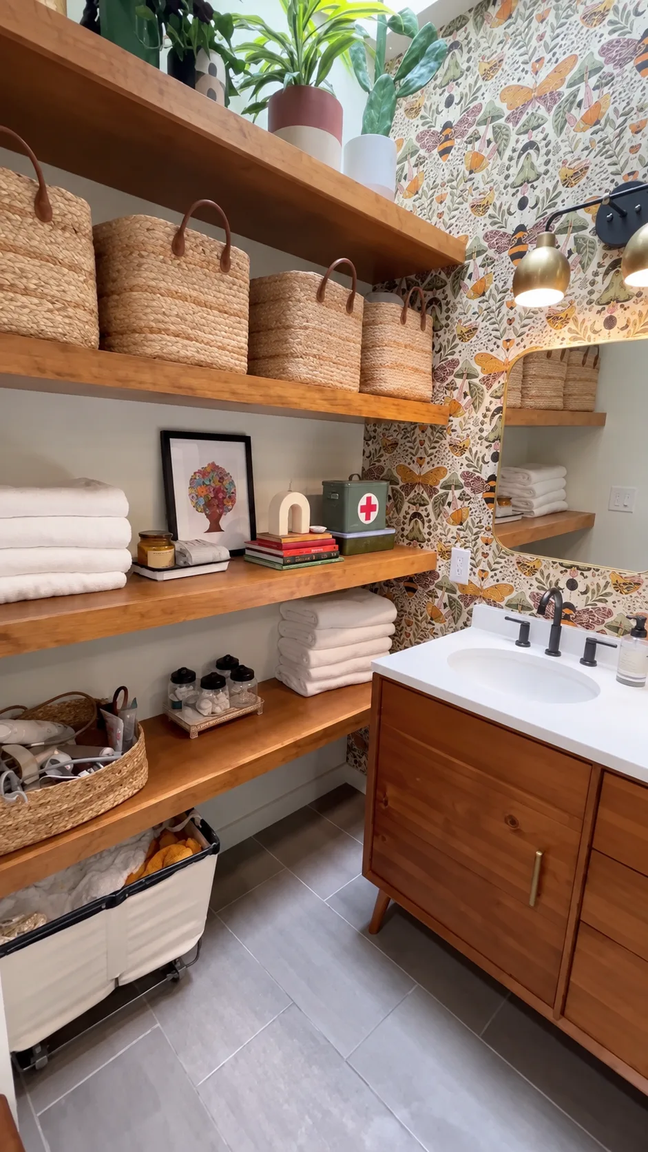Open wood shelves with towels and storage beside the walnut vanity in a Cary bathroom renovation