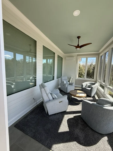 Completed Versatile Edge Walsh sunroom with abundant windows and comfortable seating